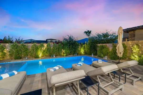 a view of an outdoor dining space with a table and chairs
