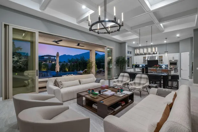 a kitchen with stainless steel appliances kitchen island granite countertop a table chairs sink and cabinets