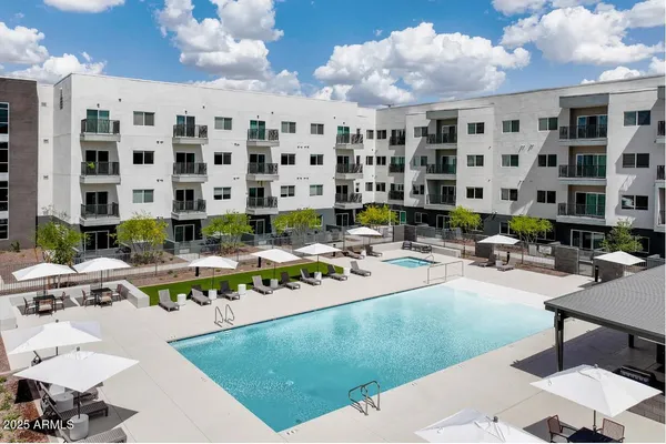 a view of a swimming pool with outdoor seating
