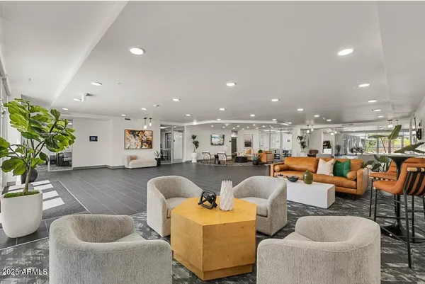 a living room with lots of furniture and kitchen view