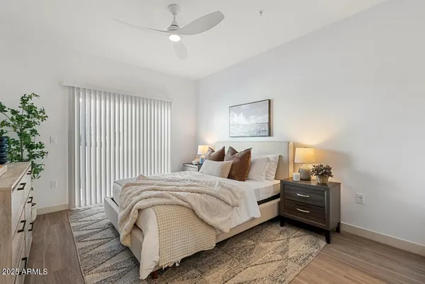 a bedroom with a bed and a potted plant