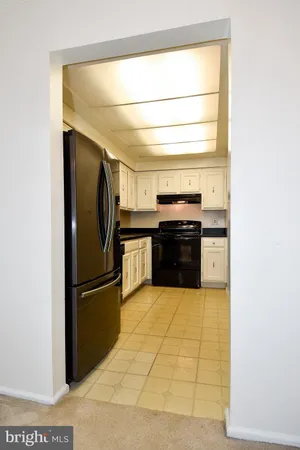 a kitchen with granite countertop a refrigerator and a stove