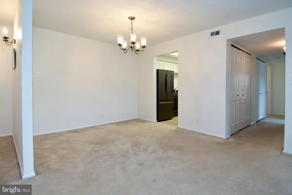 a view of empty room with a chandelier
