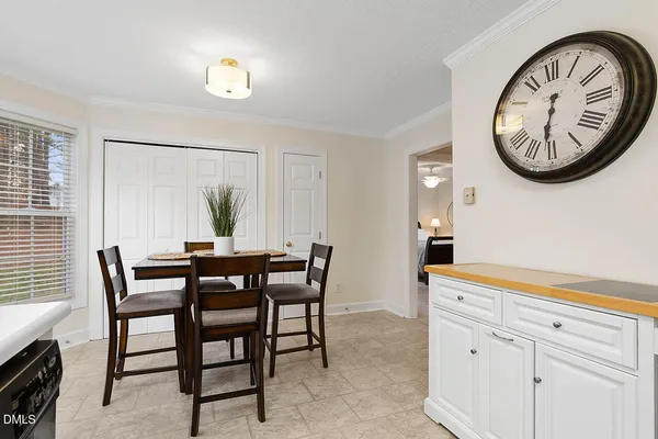 a view of a dining room with furniture and a window