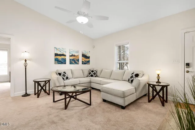 a living room with furniture and a chandelier
