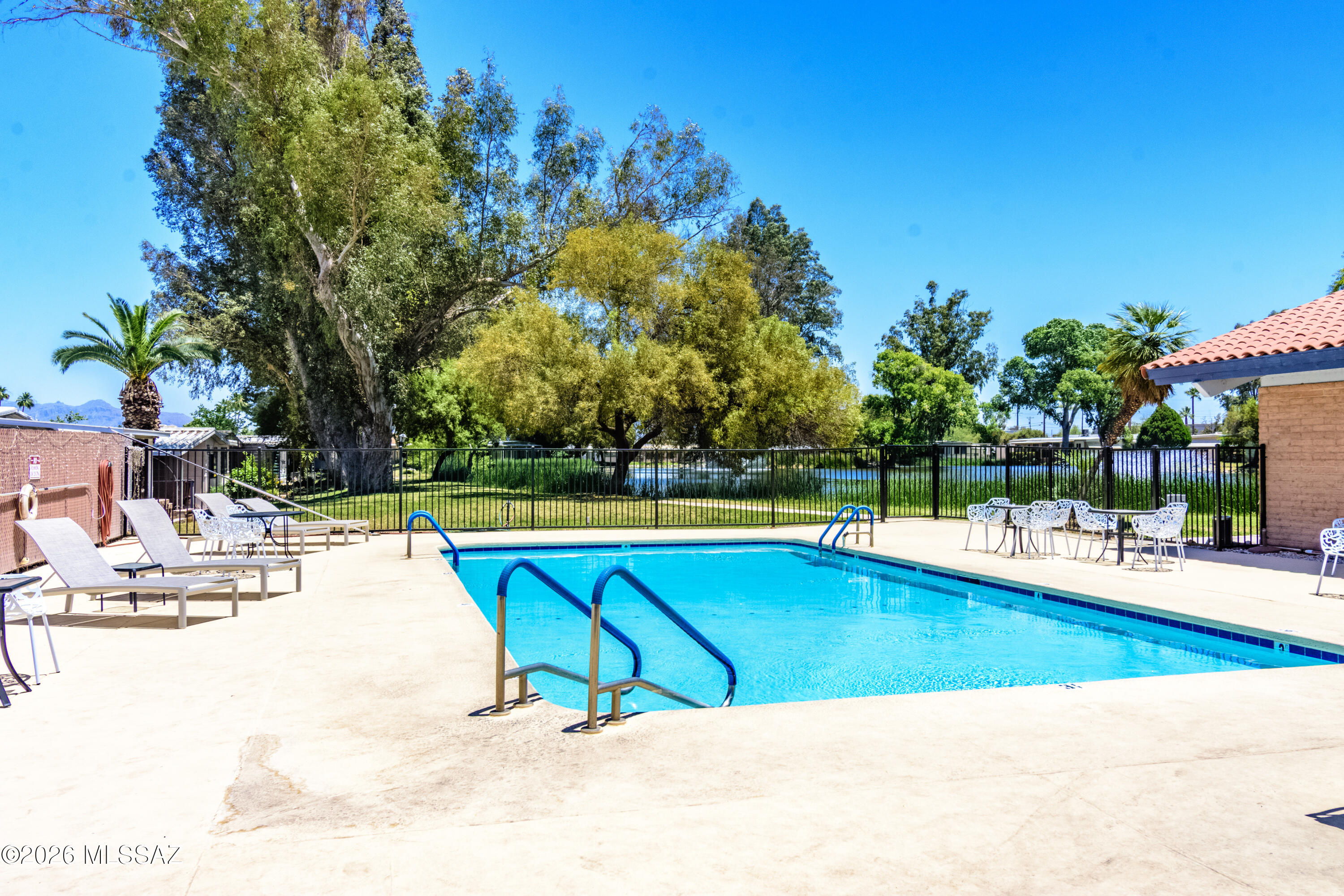 4550 North Flowing Wells Road, Unit 155 Tucson, AZ 85705 - Photo 29 of 40 a view of a swimming pool with an outdoor space and seating area