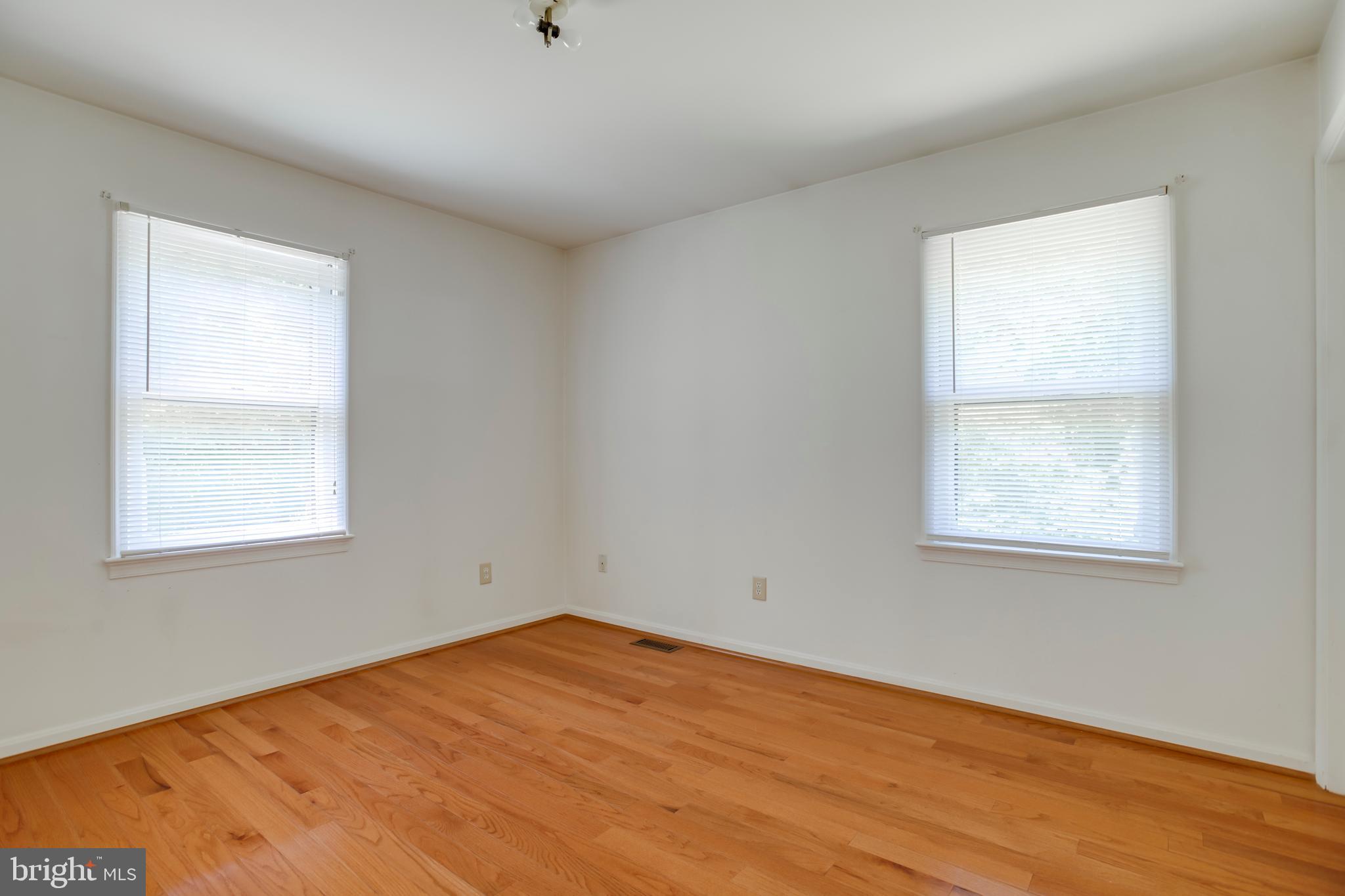 803 Weaver Hollow Road Banco, VA 22711 - Photo 12 of 67 an empty room with wooden floor and windows