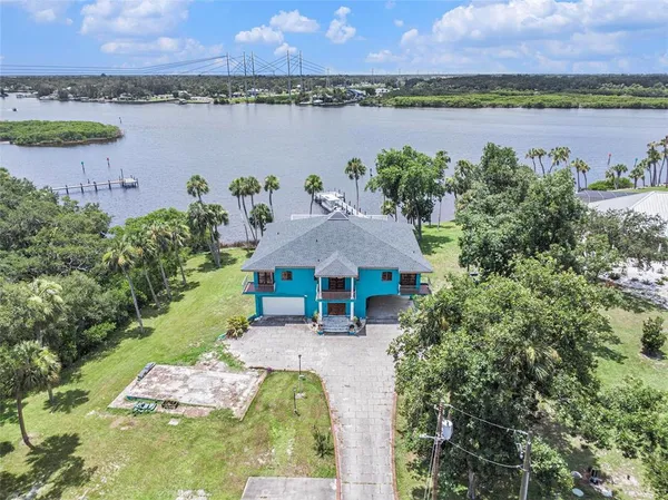 an aerial view of a house with outdoor space and lake view