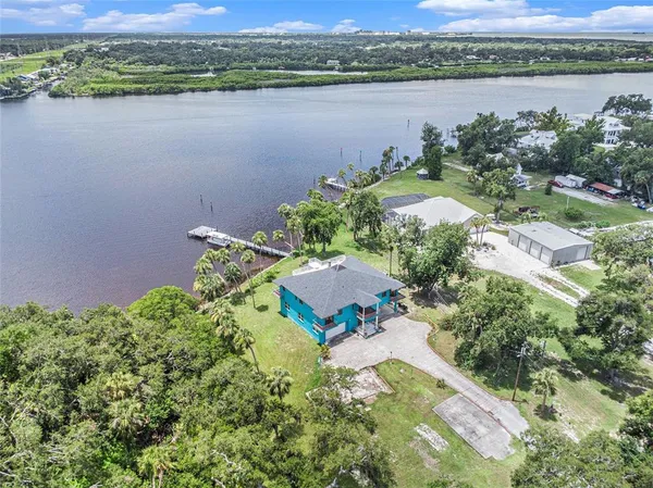 an aerial view of a house with a lake view