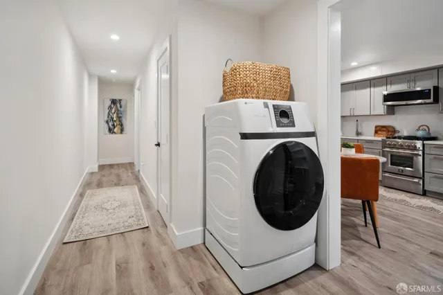 a view of a kitchen with furniture and wooden floor