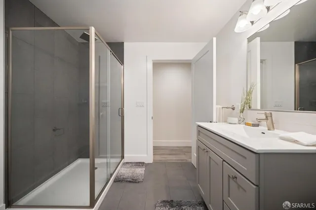 a bathroom with a sink a mirror and a shower