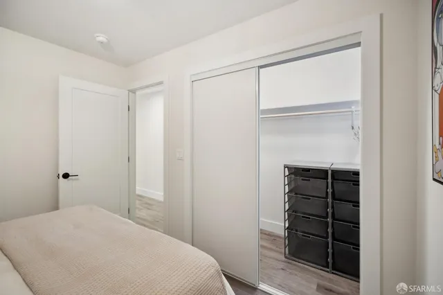 a bedroom with a bed and a closet