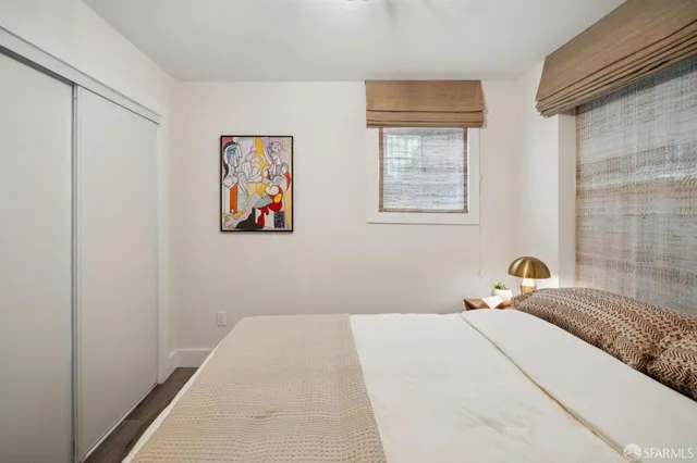 a bedroom with a bed and wall painting