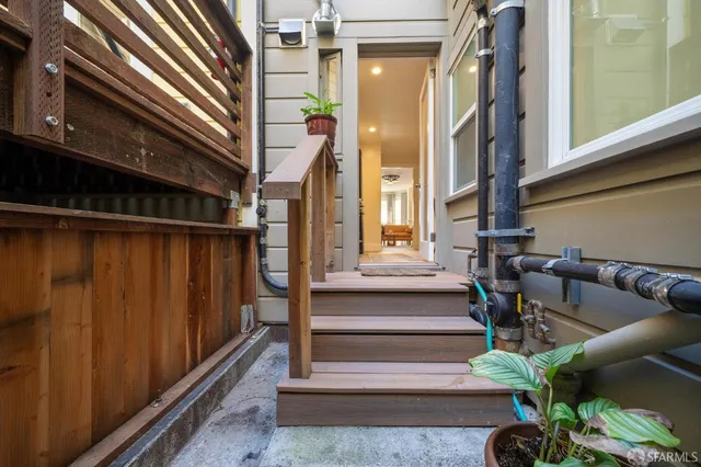 a view of entryway and hall with wooden floor