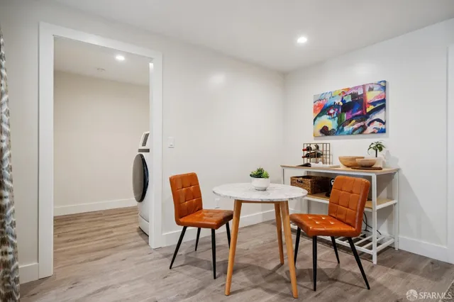 a view of a workspace with furniture and wooden floor