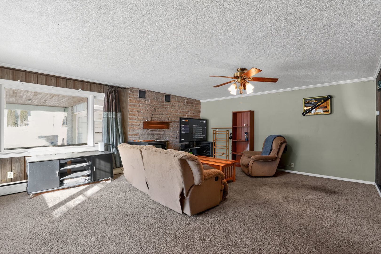2388 McFarland Road Rockford, IL 61108 - Photo 11 of 33 a living room with furniture a flat screen tv and a window