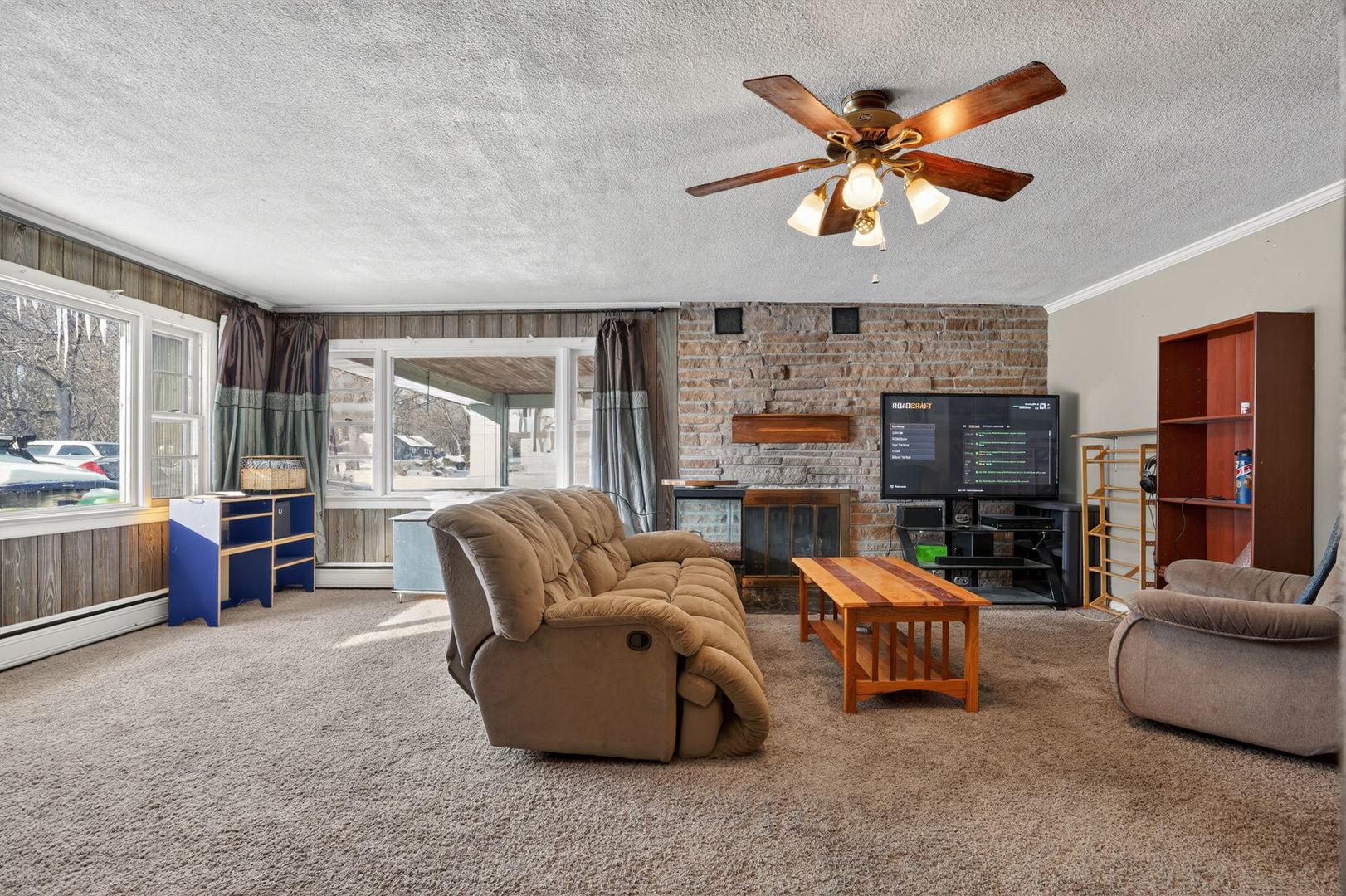 2388 McFarland Road Rockford, IL 61108 - Photo 13 of 33 a living room with furniture a ceiling fan a fireplace and a window