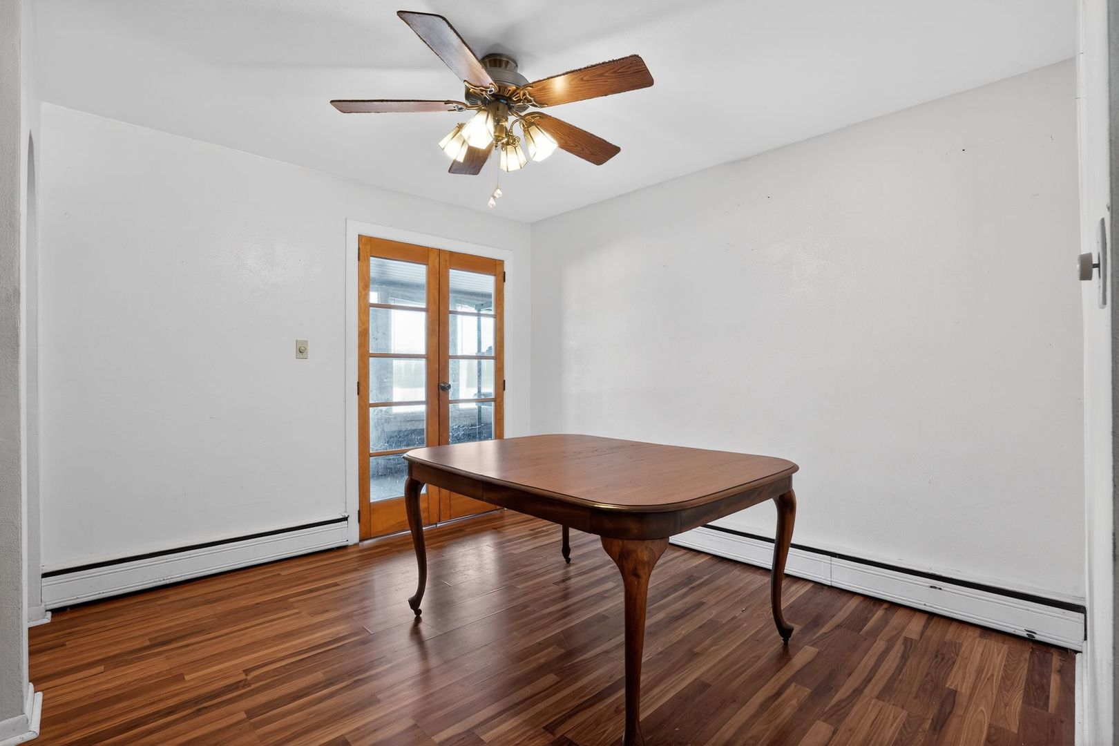 2388 McFarland Road Rockford, IL 61108 - Photo 22 of 33 a view of a room with wooden floor a ceiling fan and a window