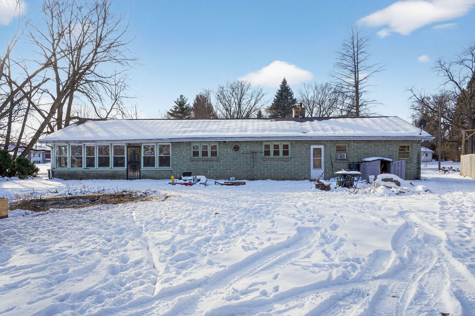 2388 McFarland Road Rockford, IL 61108 - Photo 3 of 33 a view of a house with a yard covered in snow
