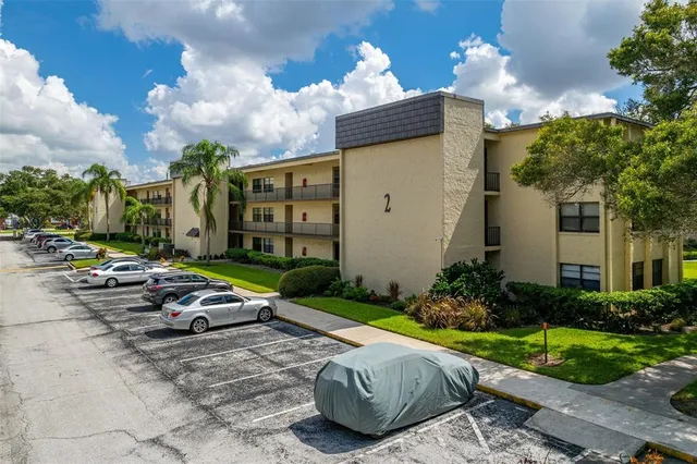 a view of a chair and table in backyard of the house