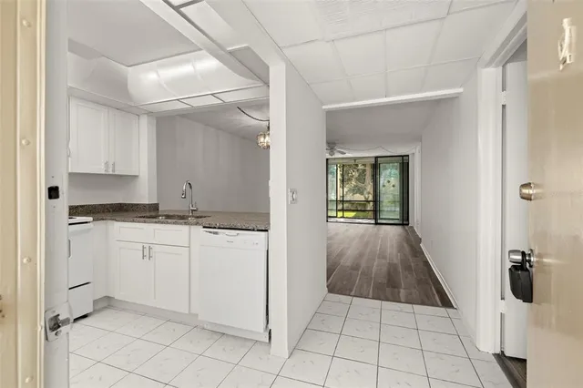 a kitchen with granite countertop a sink stainless steel appliances and cabinets