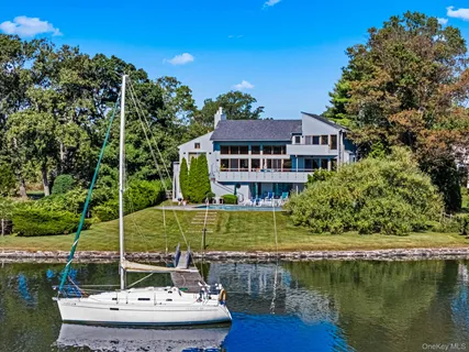 a view of a lake with a house and a yard