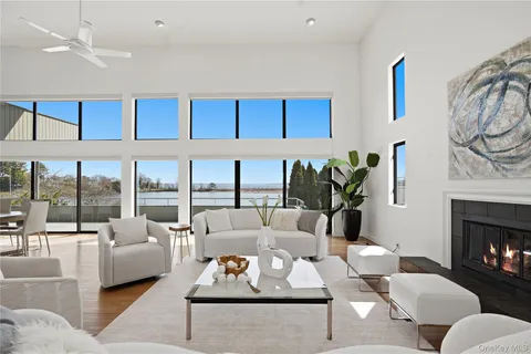 a living room with furniture fireplace and a large window with garden view
