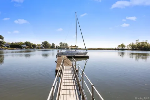 a view of a lake with boats and large trees