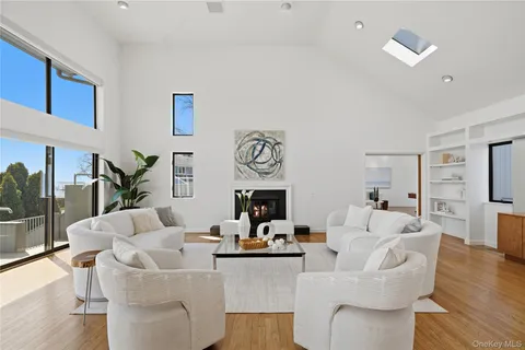 a living room with fireplace furniture and a wooden floor