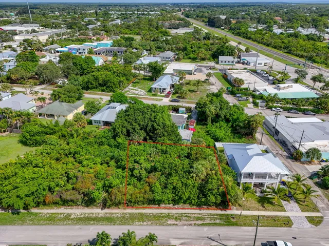 an aerial view of residential houses with outdoor space and street view
