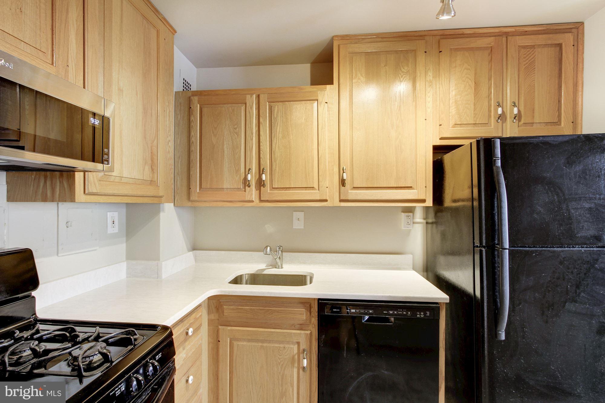 522 21st Street Northwest, Unit 301 Washington, DC 20006 - Photo 3 of 29 a kitchen with stainless steel appliances granite countertop a sink stove and refrigerator