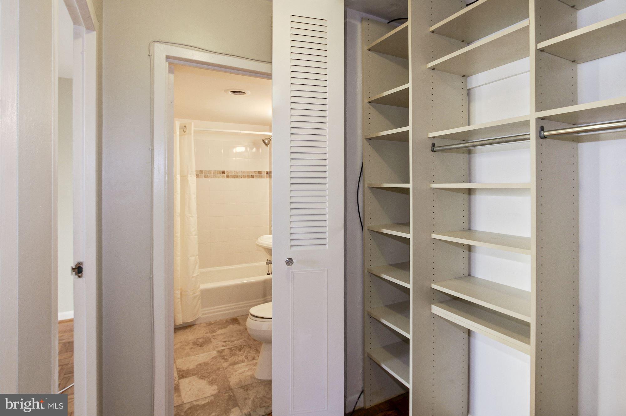 522 21st Street Northwest, Unit 301 Washington, DC 20006 - Photo 9 of 29 a bathroom with a walk in closet and a bathroom