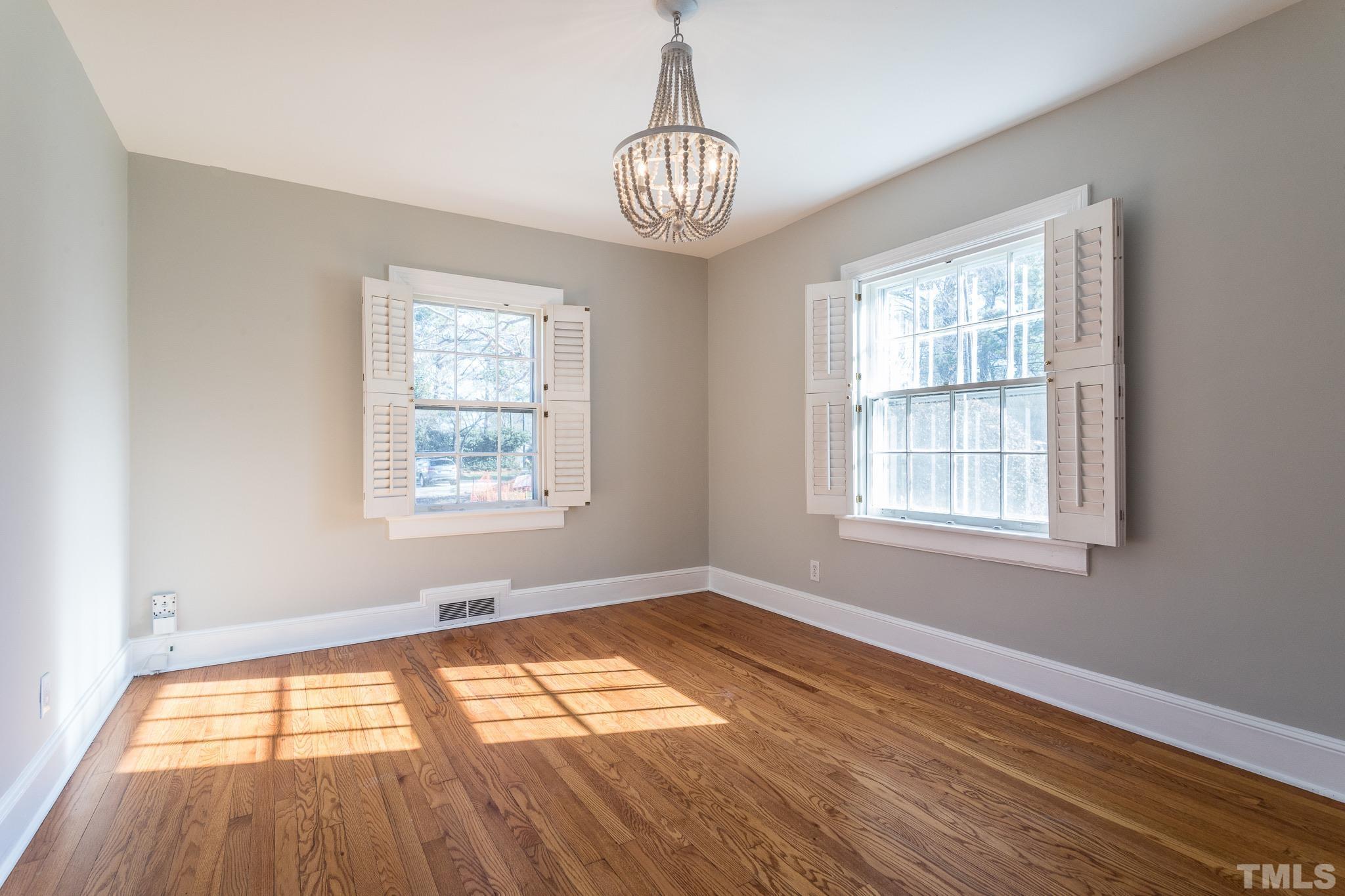 2725 Anderson Drive Raleigh, NC 27608 - Photo 11 of 27 a view of empty room with wooden floor and fan