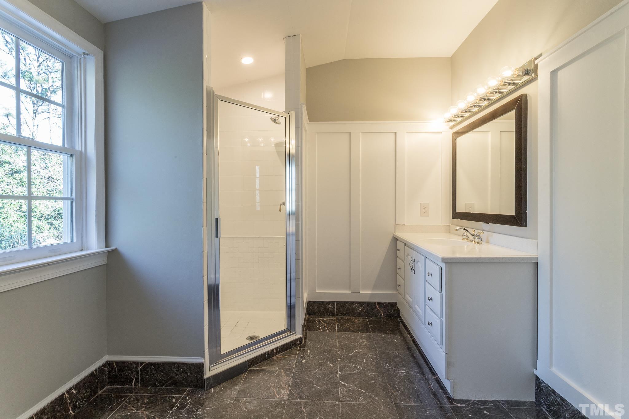 2725 Anderson Drive Raleigh, NC 27608 - Photo 21 of 27 a bathroom with a double vanity sink and mirror
