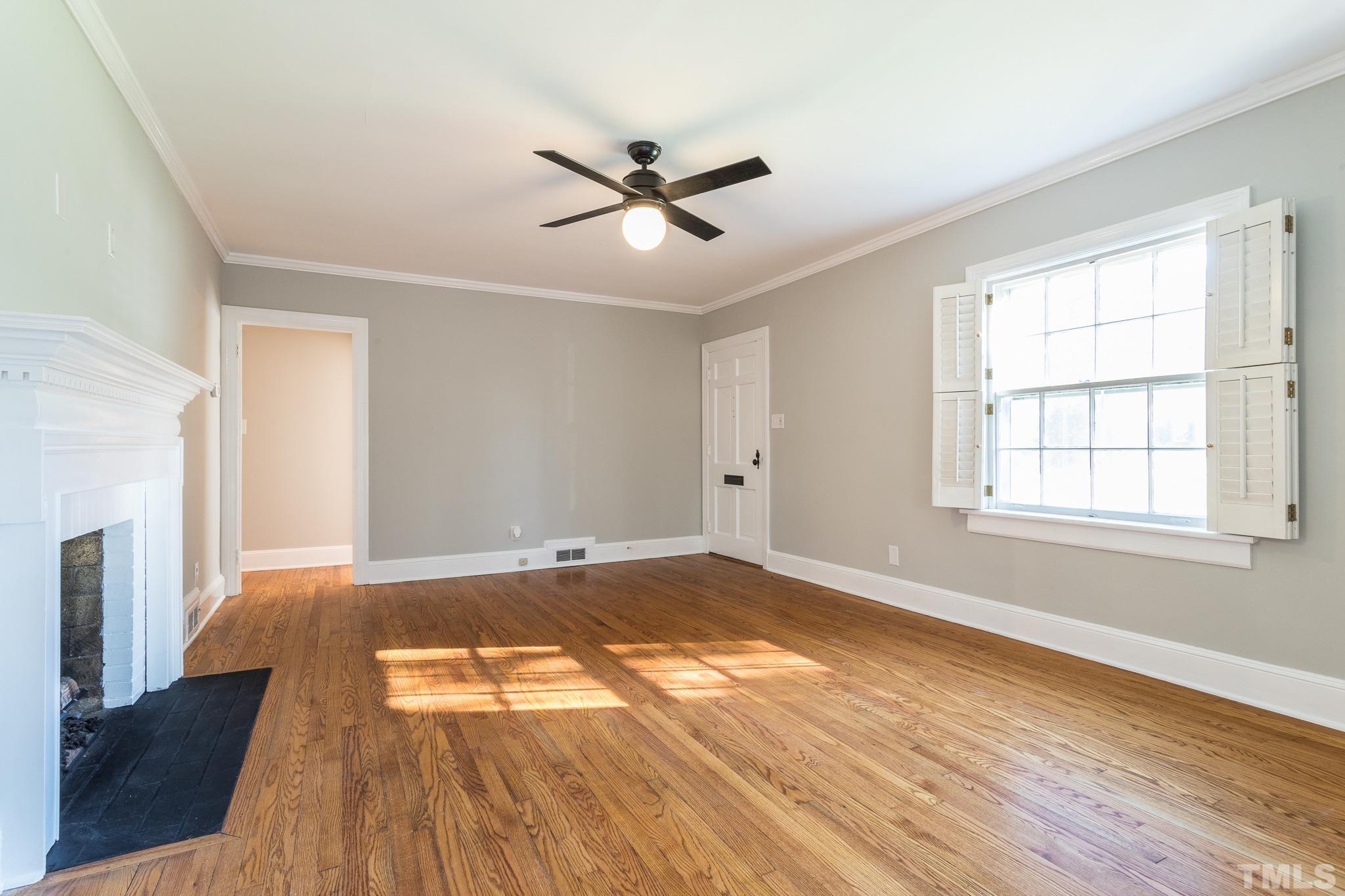 2725 Anderson Drive Raleigh, NC 27608 - Photo 5 of 27 a view of empty room with wooden floor and fan