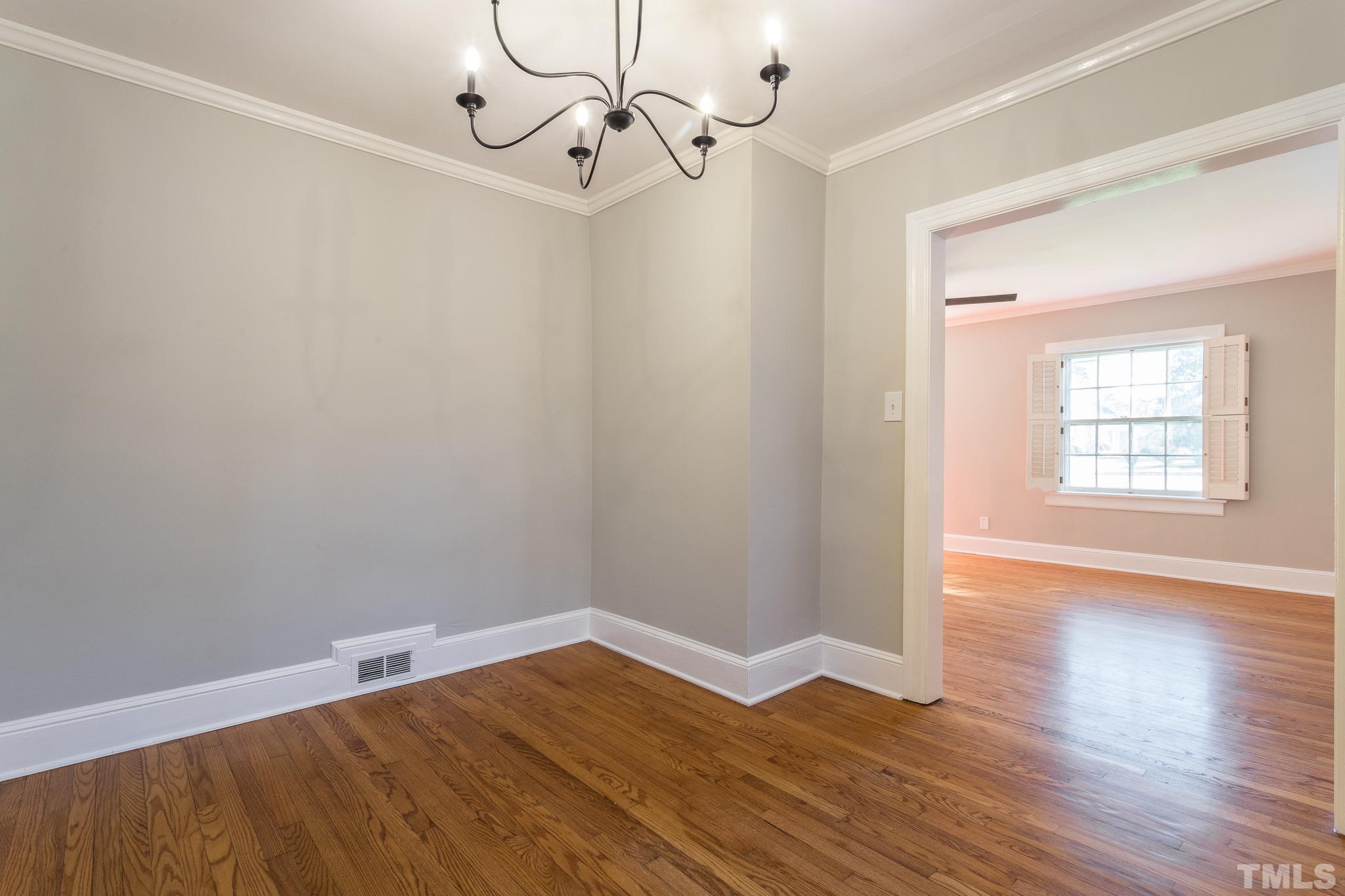 2725 Anderson Drive Raleigh, NC 27608 - Photo 6 of 27 wooden floor in an empty room with a window