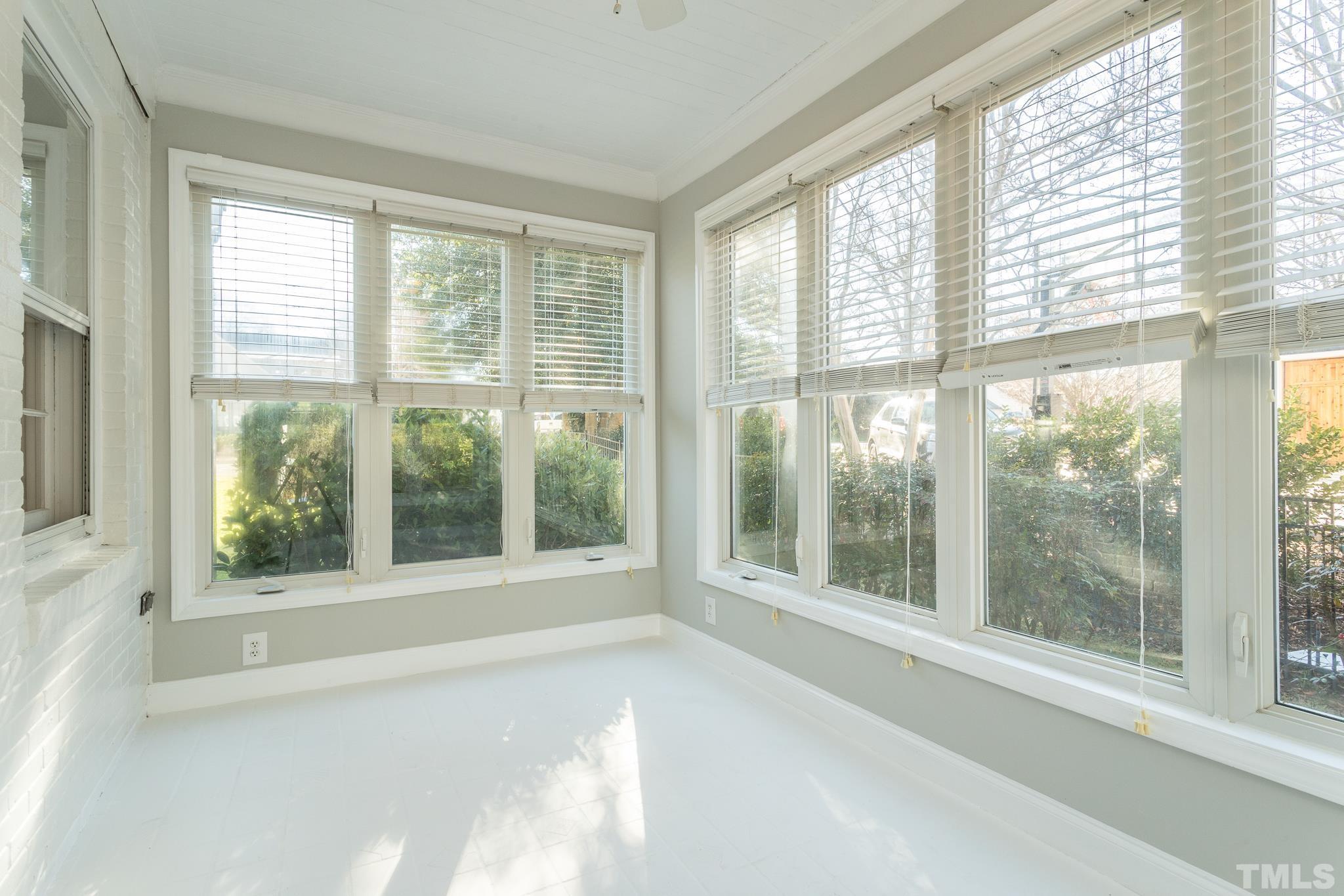 2725 Anderson Drive Raleigh, NC 27608 - Photo 8 of 27 a view of a room with a large window and a bed