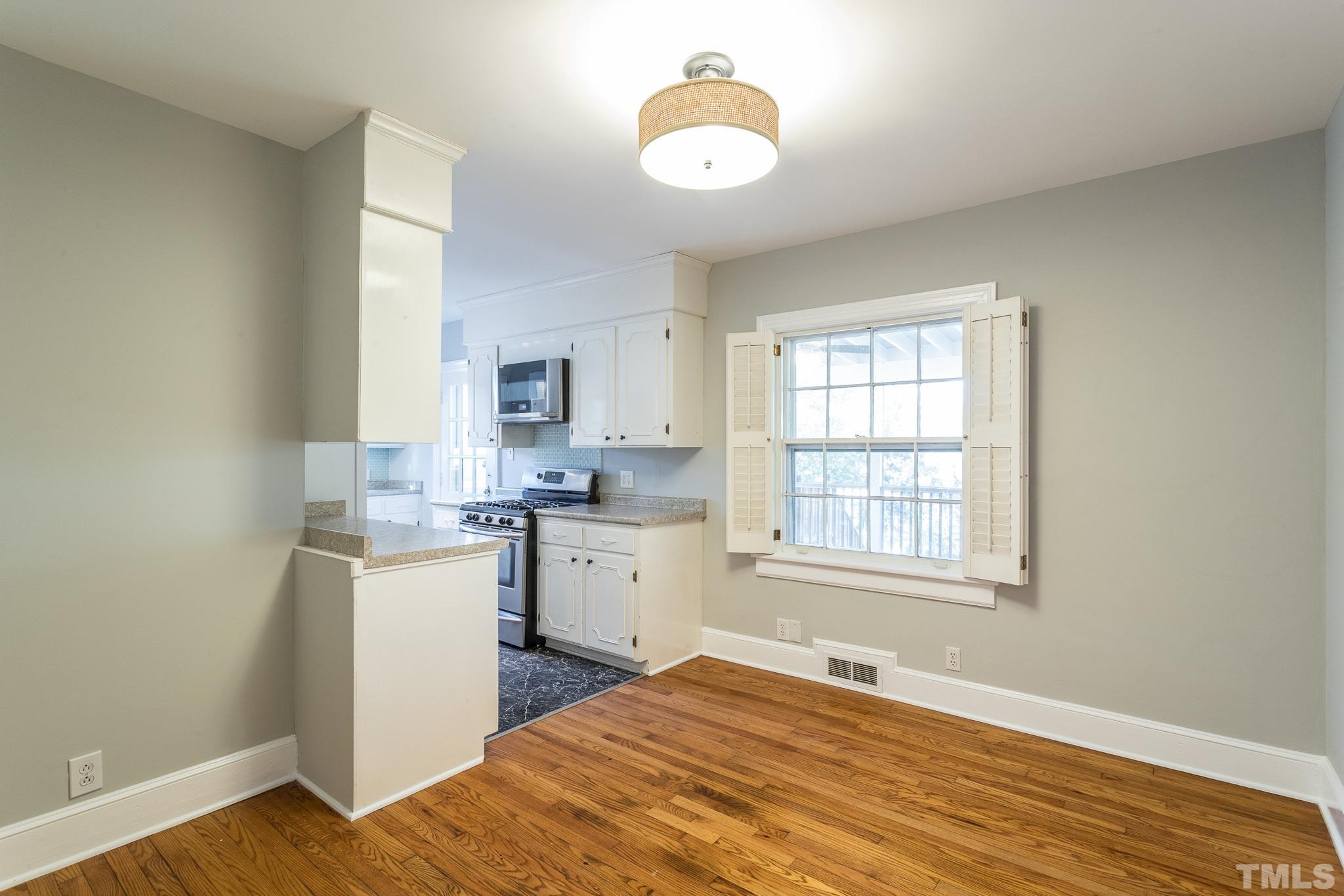 2725 Anderson Drive Raleigh, NC 27608 - Photo 9 of 27 a bedroom with a bed and wooden floor
