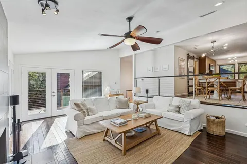 a living room with furniture and wooden floor