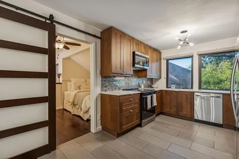 a kitchen with a refrigerator and a sink