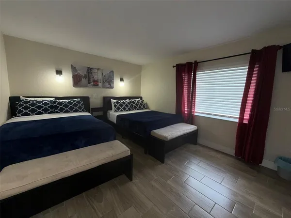 a bedroom with bed and window