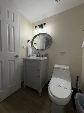 a bathroom with a toilet a sink and a mirror
