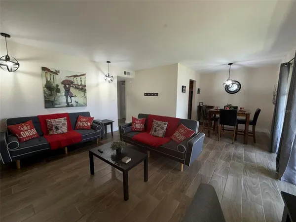 a living room with furniture and wooden floor