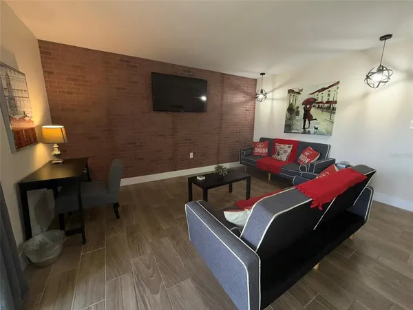 a living room with furniture and a flat screen tv