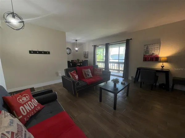 a living room with furniture and wooden floor