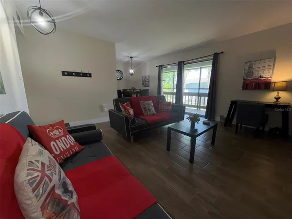 a living room with furniture rug and window