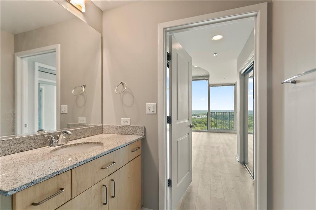 361 17th Street Northwest, Unit 1906 Atlanta, GA 30363 - Photo 14 of 28 a bathroom with a granite countertop sink and a mirror