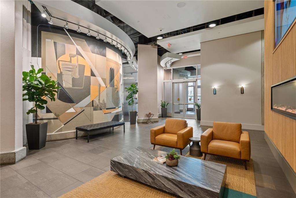 361 17th Street Northwest, Unit 1906 Atlanta, GA 30363 - Photo 28 of 28 a living room with furniture and a potted plant