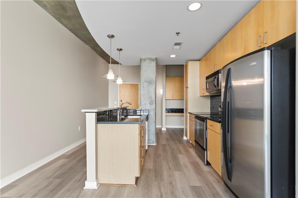 361 17th Street Northwest, Unit 1906 Atlanta, GA 30363 - Photo 4 of 28 a kitchen with stainless steel appliances a refrigerator and a stove