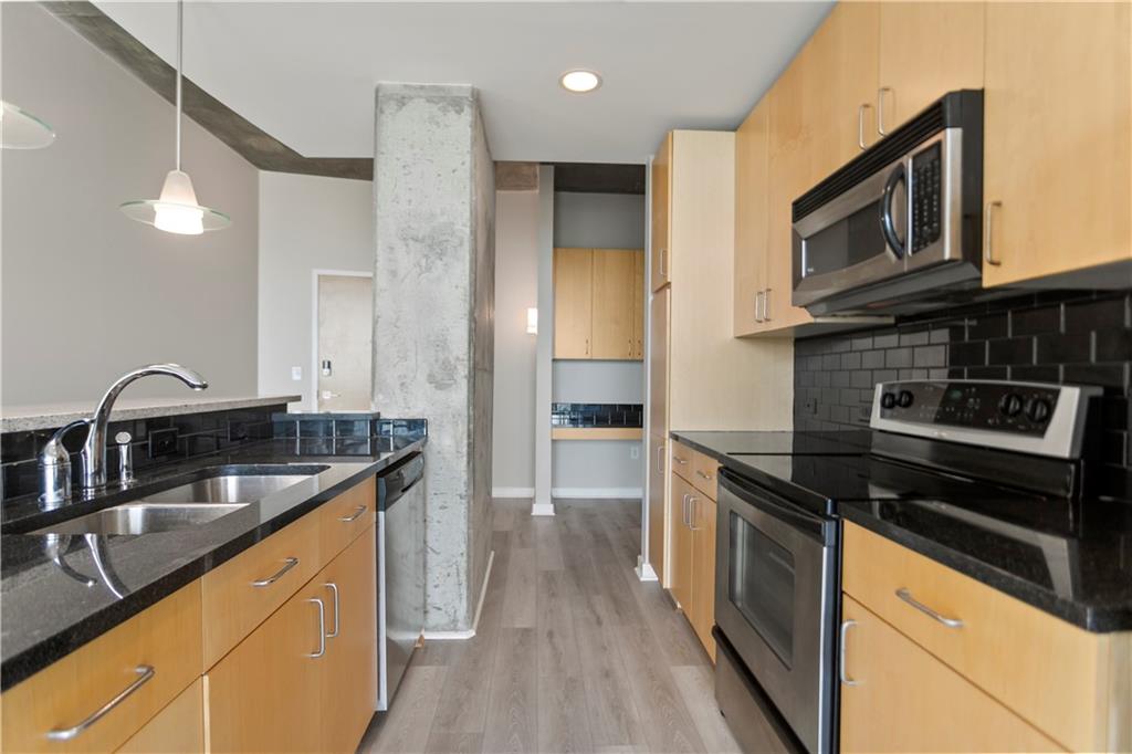 361 17th Street Northwest, Unit 1906 Atlanta, GA 30363 - Photo 7 of 28 a kitchen with stainless steel appliances granite countertop a sink stove and refrigerator